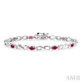 4x3 MM Oval Cut Ruby and 1/10 Ctw Round Cut Diamond Bracelet in 10K White Gold