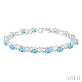 7x5 MM Oval Cut Blue Topaz and 1/20 Ctw Round Cut Diamond Fashion Bracelet in Sterling Silver
